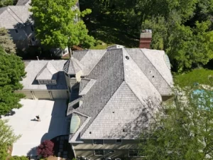 Roofing crew tearing off old shingles